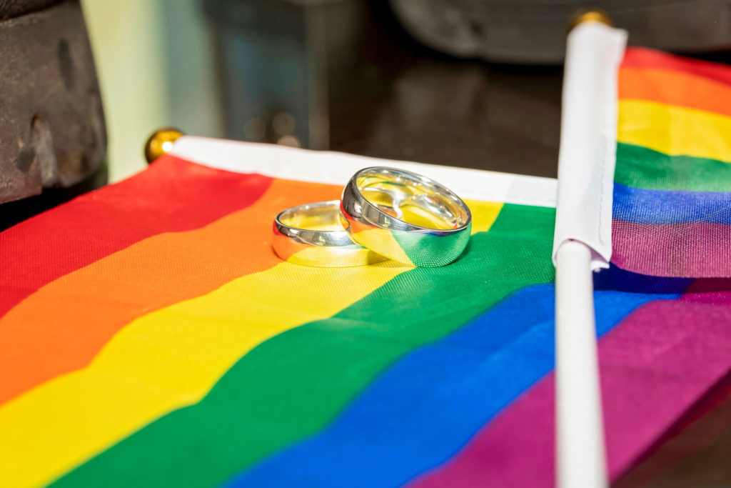 rainbow flag and wedding rings