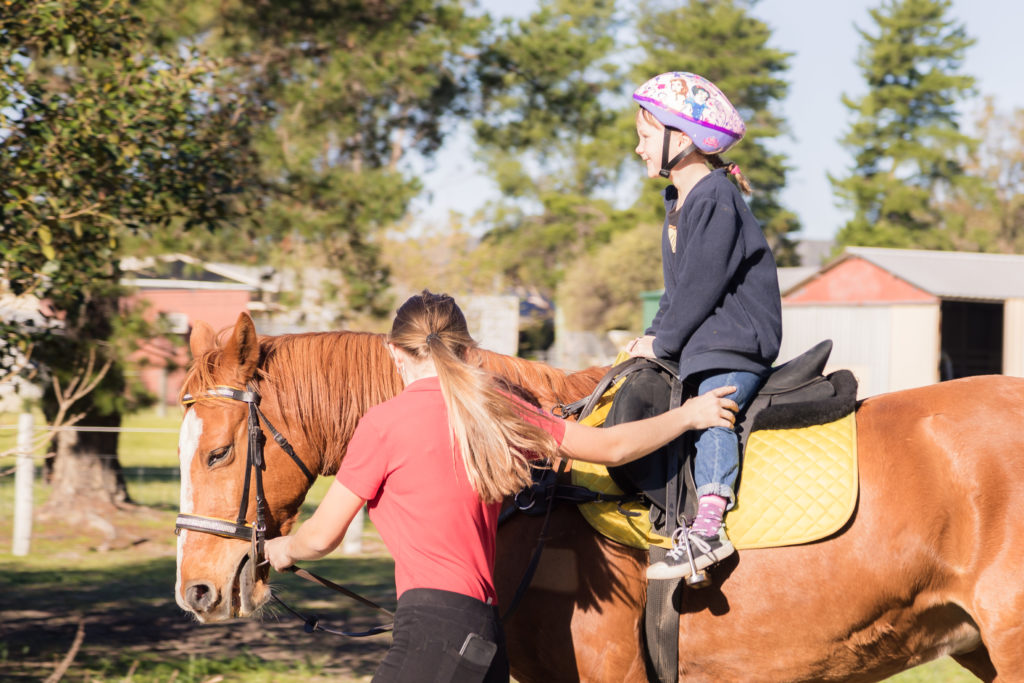 Sophie leading my youngest on her horse.