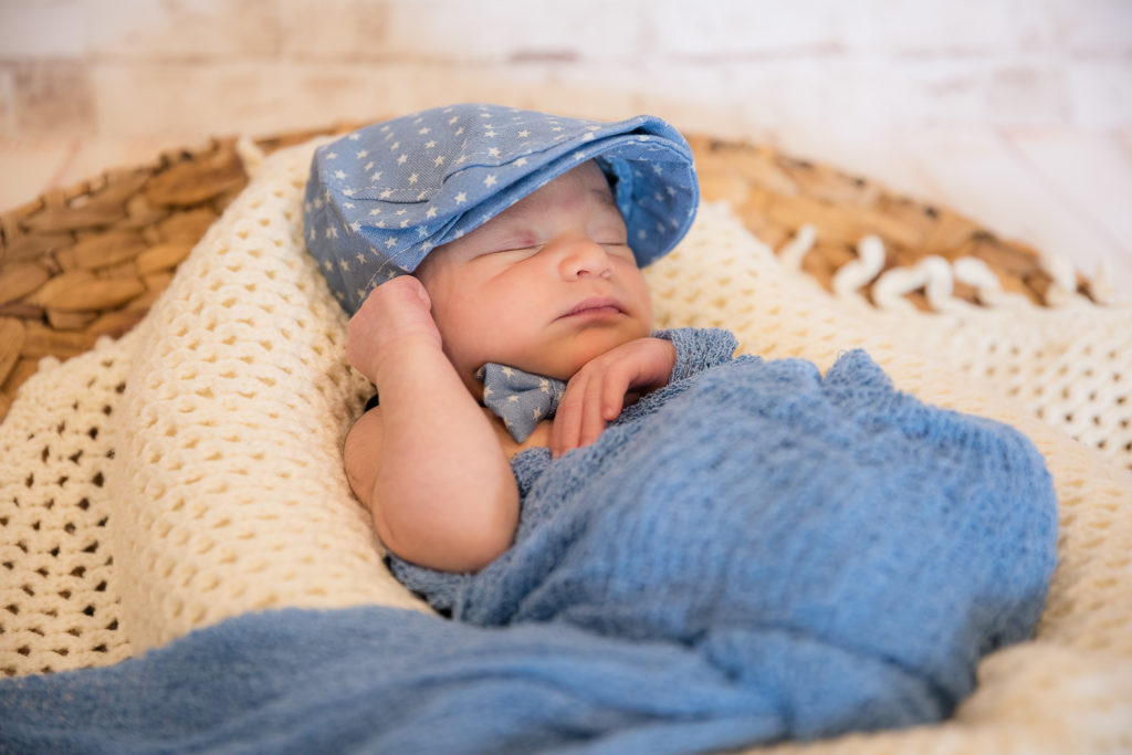 newborn photo with cap and bowtie