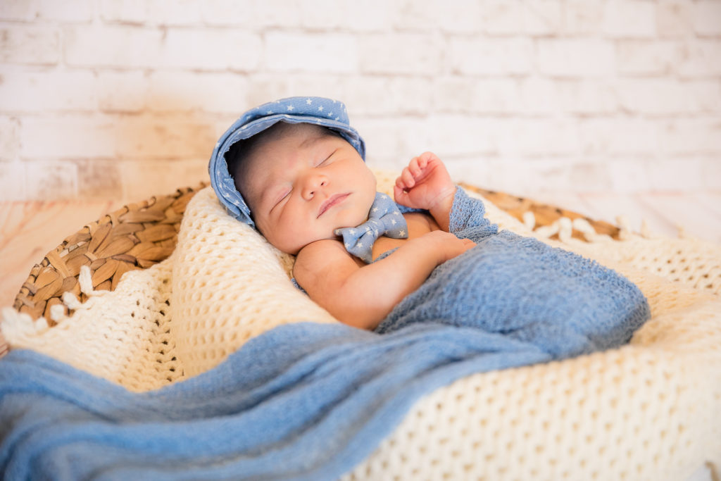 newborn photo with cap and bowtie